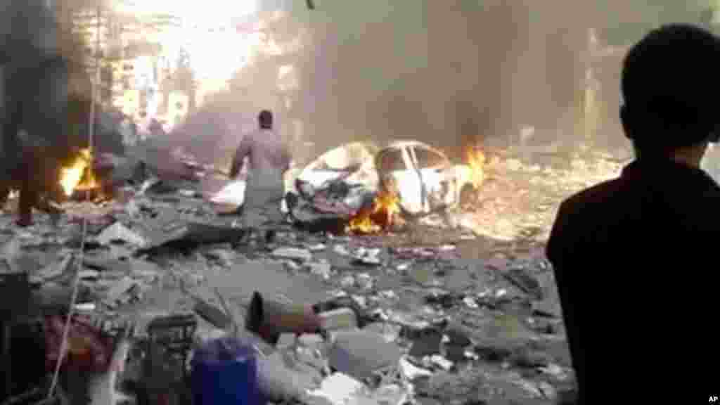 The aftermath of a car bomb attack on a market in the town of Darkoush in Idlib province, Monday, Oct. 14, 2013.