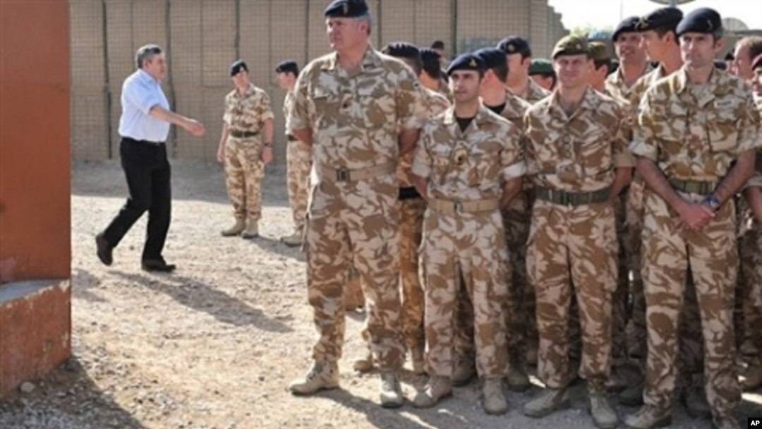 British Prime Minister Gordon Brown (L) arrives to greet soldiers at Lashkar Gah base, Helmand Province, Afghanistan, 06 Mar 2010