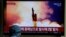 FILE - A man watches a TV broadcast showing a file photo for a news report on North Korea firing two unidentified projectiles, in Seoul, South Korea, March 2, 2020. 