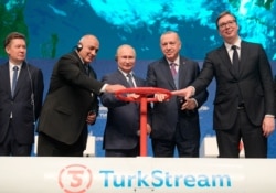 Turkey's President Recep Tayyip Erdogan, second right, and Russia's President Vladimir Putin, center, and others symbolically open a valve during a ceremony in Istanbul for the inauguration of the TurkStream pipeline, Jan. 8, 2020.