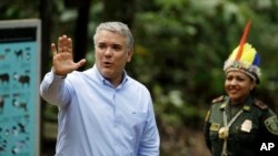 Colombia's President Ivan Duque waves upon his arrival for a meeting with leaders of several South American nations that share the Amazon, in Leticia, on Colombia's Amazon river border with Brazil and Peru, Sept. 6, 2019.