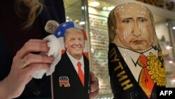 An employee polishes traditional Russian wooden nesting dolls depicting Donald Trump (L), U.S. president-elect at the time, and Russian President Vladimir Putin at a gift shop in central Moscow, Russia, Jan. 16, 2017. Russians have largely greeted Donald Trump's ascendancy to the White House with high hopes for a new era of improved relations.