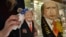 An employee polishes traditional Russian wooden nesting dolls depicting Donald Trump (L), U.S. president-elect at the time, and Russian President Vladimir Putin at a gift shop in central Moscow, Russia, Jan. 16, 2017. Russians have largely greeted Donald Trump's ascendancy to the White House with high hopes for a new era of improved relations.