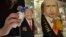 An employee polishes traditional Russian wooden nesting dolls depicting Donald Trump (L), U.S. president-elect at the time, and Russian President Vladimir Putin at a gift shop in central Moscow, Russia, Jan. 16, 2017.