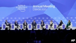 President of the World Economy Forum Borge Brende, U.S. Sen. Chris Coons, Georgia Gov. Brian Kemp, Gov. J.B. Pritzker of Illinois, Sen. Joe Manchin, Sen. Kyrsten Sinema, Rep. Maria Elvira Salazar, and Rep. Mikie Sherrill in Davos, Switzerland on Tuesday, Jan. 17, 2023. 