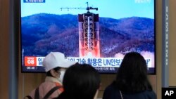 A TV screen shows a file image of North Korea's rocket launch during a news program at the Seoul Railway Station in Seoul, South Korea, May 29, 2023. Japan's coast guard said North Korea has notified it that it plans to launch a satellite in coming days.