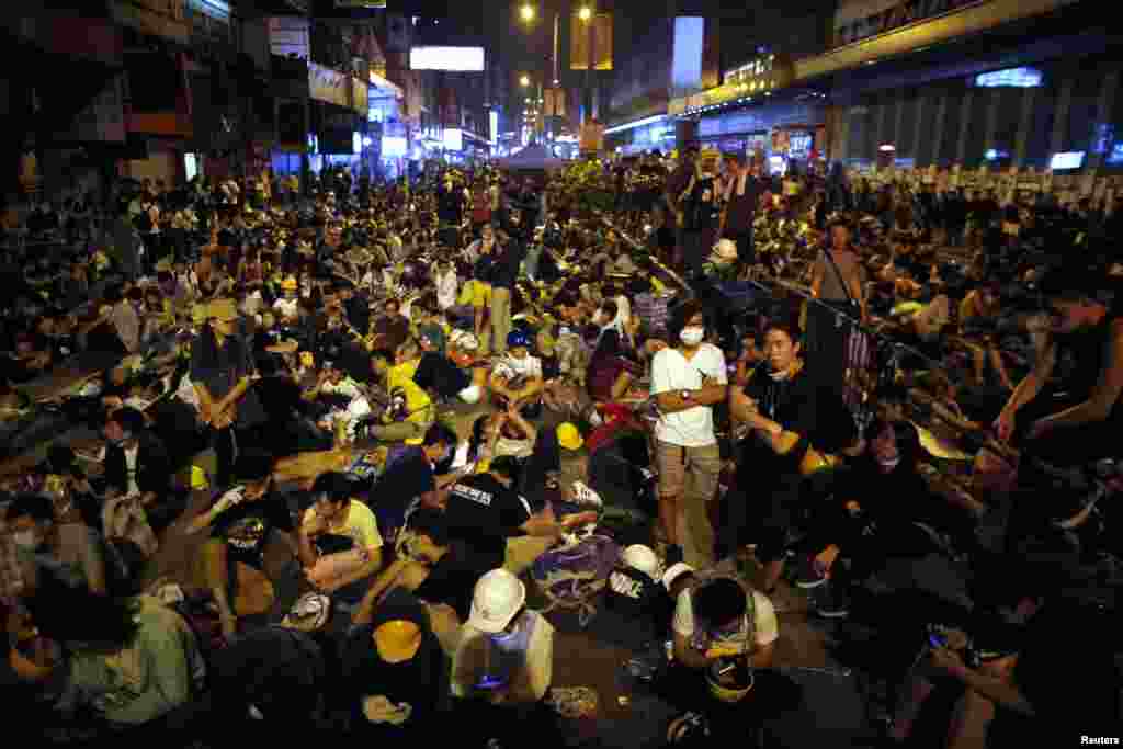 Pro-democracy protesters sit on a street as they block an area of the Mongkok shopping district of Hong Kong Oct. 20, 2014.