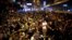 Pro-democracy protesters sit on a street as they block an area of the Mongkok shopping district of Hong Kong Oct. 20, 2014.