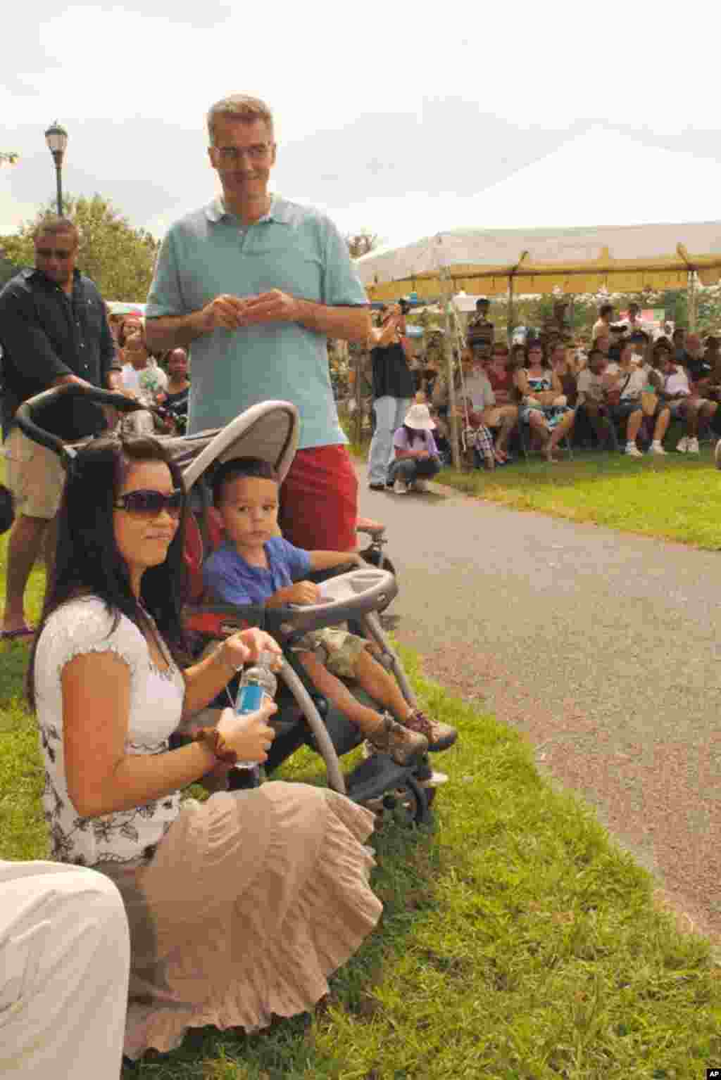 Irish-American Donald Joy, his Cambodian wife Sythuon Joy, and their two-and-half-year-old son, Jasper Joy look on the dance performance.