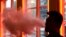FILE - A patron exhales vapor from an e-cigarette at the Henley Vaporium in New York