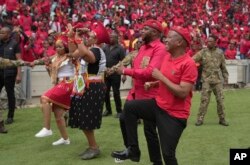 FILE - Economic Freedom Fighters leader Julius Malema,centre, smiles and dances while greeting supporters upon his arrival at Moses Mabhida Stadium in KwaZulu Natal province, South Africa, February 10, 2024