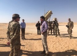 FILE - U.S. Defense Secretary Mark Esper speaks with U.S. troops in front of a Patriot missile battery at Prince Sultan Air Base in Saudi Arabia, Oct. 22, 2019.