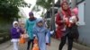 FILE - Indonesian girls with their mother leave a school-turned-clinic after the daughters were circumcised in Bandung, Feb. 10, 2013.