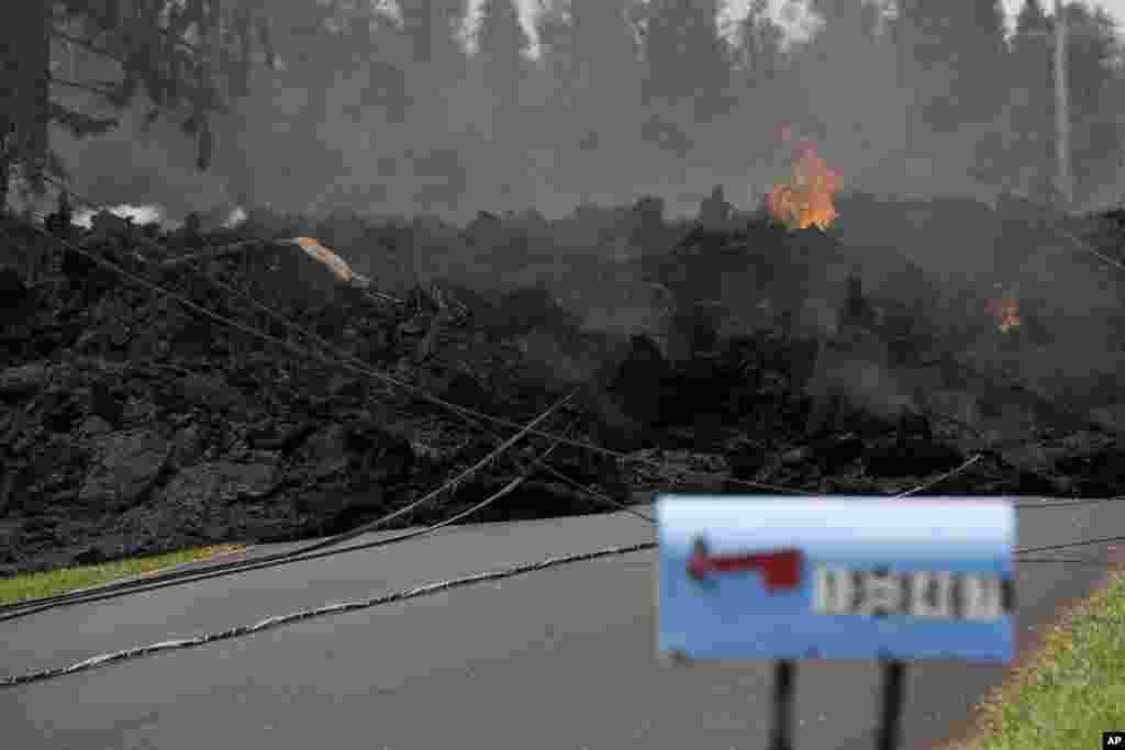 A mail box stands near the lava flow in the Leilani Estates, Saturday, May 5, 2018, in Pahoa, Hawaii. The Hawaiian Volcanoes Observatory said eight volcanic vents opened in the Big Island residential neighborhood of Leilani Estates since Thursday.