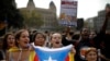 People wearing yellow ribbons in support of jailed pro-independence politicians and carrying Estelada pro-independence flags protest in Barcelona, Spain, Oct. 14, 2019.