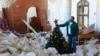 A man sets up a Christmas tree amidst the rubble of the Melkite Church, which was hit by an Israeli airstrike on Oct. 9, in the southern Lebanese village of Derdghaya on Dec. 20, 2024.