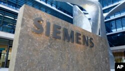 FILE -The logo of German industrial conglomerate Siemens is pictured at the headquarters in Munich, Germany. 