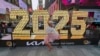 A dancer poses for photos in front of the 2025 New Year's Eve numerals in Times Square, Dec. 18, 2024, in New York. 