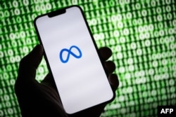 This illustration taken on October 30, 2023, shows the Meta (former Facebook) logo on a smartphone in Mulhouse, eastern France. (Photo by SEBASTIEN BOZON / AFP)