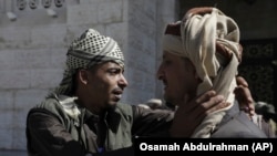 A prisoner detained by the Houthis is greeted by his father after his release, in Sanaa, Yemen, Jan. 25, 2025.