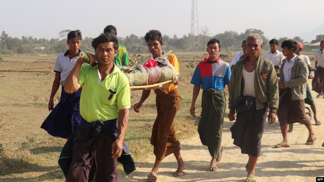 FILE - Residents carry the body of an ethnic Rakhine woman for burial in Rathedaung township, after fresh fighting in Rakhine state between the Myanmar military and the Arakan Army, an ethnic Rakhine force, Feb. 21, 2019.