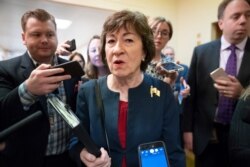 FILE - Sen. Susan Collins, R-Maine, is surrounded by reporters as she heads to vote at the Capitol in Washington, Nov. 6, 2019.