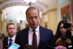 FILE - Senate Minority Whip John Thune speaks to reporters at the Capitol in Washington, June 23, 2021.