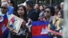 Supporters of the Cambodian Prime Minister Hun Sen gather and carry pictures of him as they demonstrate outside United Nations headquarters on Friday, Sept. 28, 2018, in New York. (Sun Narin/VOA Khmer)