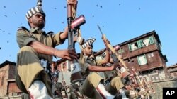 Policemen take part in Kashmir Martyrs Day ceremonies at the Martyrs graveyard in Srinagar July 13, 2011