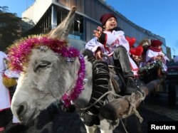 FILE - A boy rides a donkey during the traditional religious procession Alilo celebrating Orthodox Christmas in Tbilisi, Georgia, January 7, 2024.