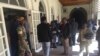 Ready to pounce ... Members of the Zimbabwe National Army, state security agents and police outside Parliament of Zimbabwe.