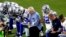 FILE - The Dallas Cowboys, led by owner Jerry Jones, center, take a knee before the national anthem at an NFL football game against the Arizona Cardinals, in Glendale, Ariz., Sept. 25, 2017.