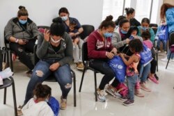 Asylum-seeking migrants from Central America, who were airlifted from Brownsville to El Paso, Texas, and deported from the U.S., wait inside the office of the Center for Integral Attention to Migrants in Ciudad Juarez, Mexico, March 16, 2021.
