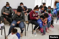 Asylum-seeking migrants from Central America, who were airlifted from Brownsville to El Paso, Texas, and deported from the U.S., wait inside the office of the Center for Integral Attention to Migrants in Ciudad Juarez, Mexico, March 16, 2021.