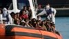 Migrants, picked up at sea, enter the port of Roccella Jonica, Calabria region, southern Italy, Nov. 14, 2021. 