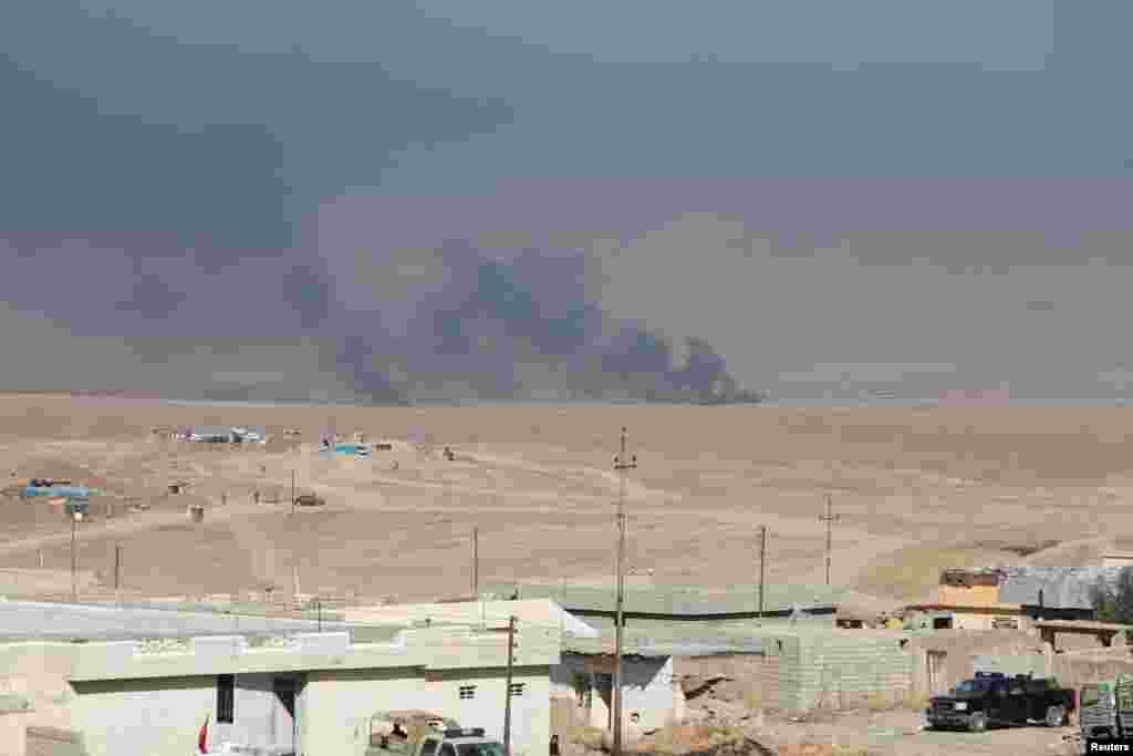 Smoke rises from clashes in the east of Mosul during clashes with Islamic State militants, Iraq, Oct. 17, 2016.