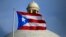 FILE - The Puerto Rican flag flies in front of the U.S. territory's Capitol in San Juan, Puerto Rico, July 29, 2015.