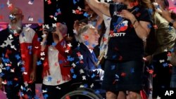 FILE - Confetti falls as Texas Gov. Greg Abbott, center, greets supporters after speaking at the Texas GOP Convention, in San Antonio, June 15, 2018.