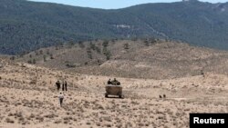 FILE - Tunisian soldiers patrol near Mount Chaambi in Kasserine region near the border with Algeria.