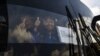 Venezuelan opposition deputies wave while traveling in a caravan of buses heading to the border with Colombia to bring in US-supplied humanitarian aid, in Caracas on Feb. 21, 2019. 