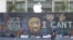 FILE - A pedestrian walks past a boarded-up Apple Store covered in street art in Portland, Ore., July 13, 2020. While most demonstrations in the city have been peaceful, nightly violent clashes between police and protesters have divided the city.