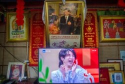FILE - A TV beneath a likeness of China's president shows a broadcast of a talk show in Zhaxigang village, Tibet Autonomous Region, June 4, 2021. China on Sept. 2, 2021, announced moves aimed at enforcing official morality.