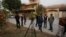Pakistani journalists and local residents gather out the home of Salman Haider, a university professor and rights activists, following news of his return, in Islamabad, Pakistan, Jan, 28, 2017.