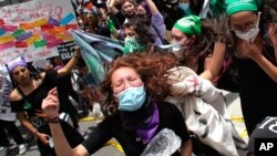 Women shout during a march ahead of International Women's Day in Quito, Ecuador, March 7, 2021. 