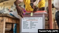 Ouverture d'une urne dans un bureau de vote lors de l'élection d'un nouveau parlement à Cotonou le 28 avril 2019.