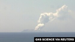 Smoke bellows from Whakaari, also known as White Island, volcano as it erupts in New Zealand, December 9, 2019, in this image obtained via social media.