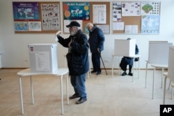 A man casts his ballot during presidential elections, at a polling station in Zagreb, Croatia, Dec. 29, 2024.