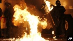 Petrol bomb hits riot police after being thrown by loyalist rioters in north Belfast, Northern Ireland, July 13, 2013.
