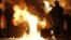 Petrol bomb hits riot police after being thrown by loyalist rioters in north Belfast, Northern Ireland, July 13, 2013.