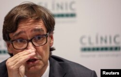 FILE - Spain's Health Minister Salvador Illa speaks at Hospital Clinic in Barcelona, Spain, Feb. 12, 2020.